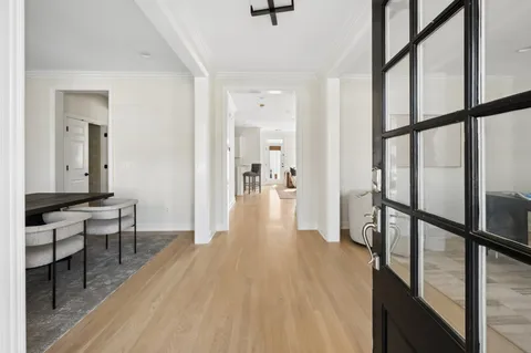 a view of a hallway view with wooden floor and staircase