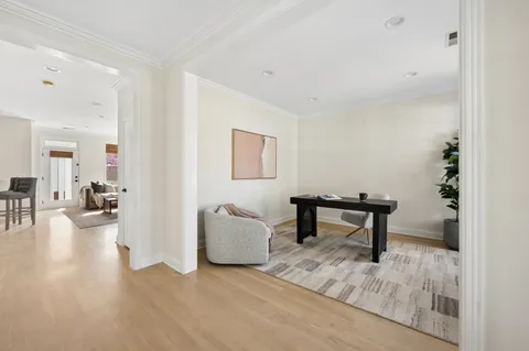 a view of a livingroom with furniture and a kitchen area