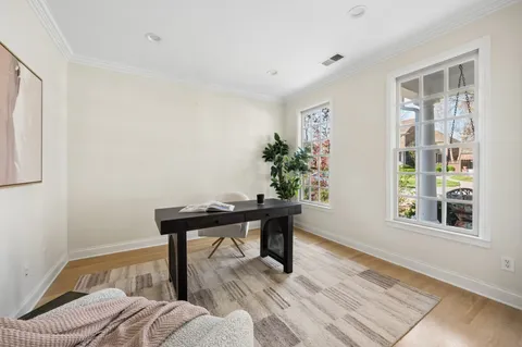 a view of a workspace with furniture and a window