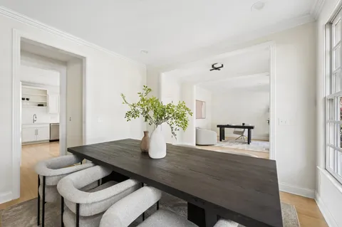 a dining room with furniture and wooden floor