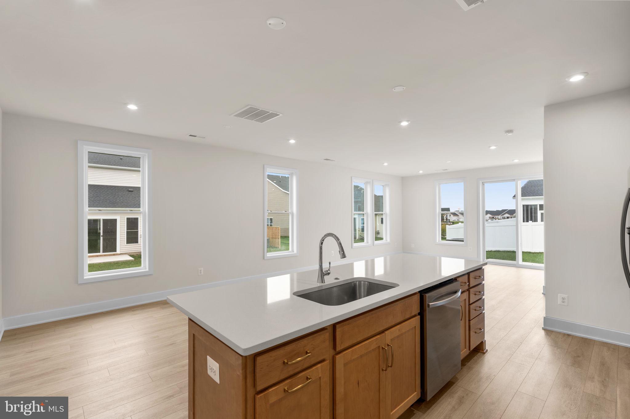 116 Keystone Lane, Unit HOMESITE 1097 Winchester, VA 22603 - Photo 15 of 42 a kitchen with stainless steel appliances granite countertop a sink a stove and a wooden floors