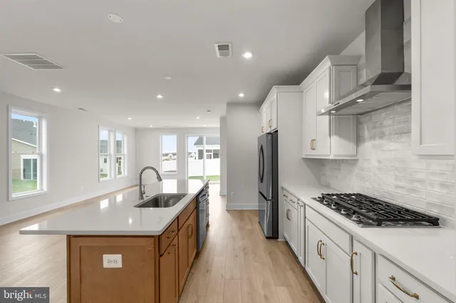 a kitchen with counter top space sink stove and refrigerator