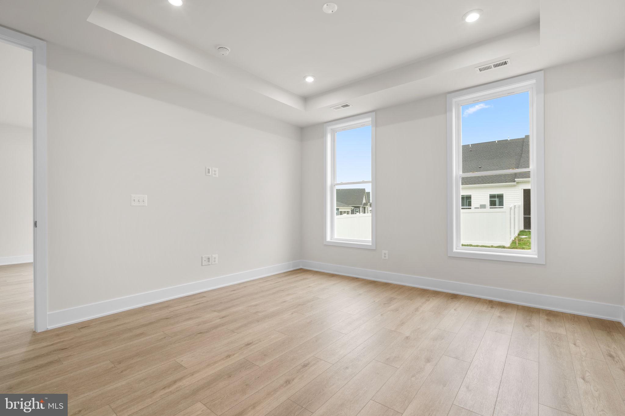 116 Keystone Lane, Unit HOMESITE 1097 Winchester, VA 22603 - Photo 20 of 42 an empty room with wooden floor and windows
