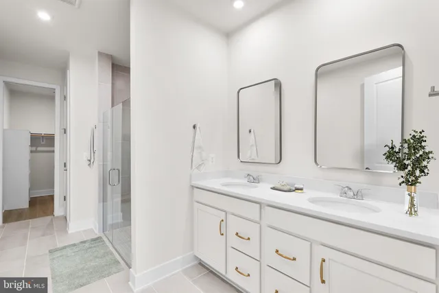 a bathroom with double sink and a mirror