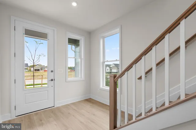 a view of entryway with wooden floor and stairs