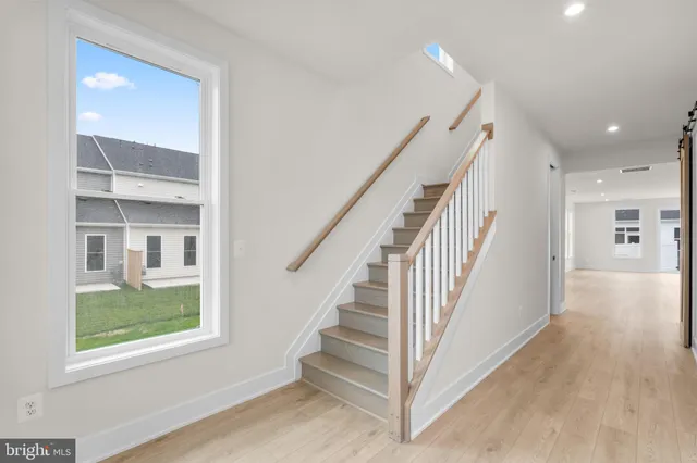 a view of entryway and hall with wooden floor