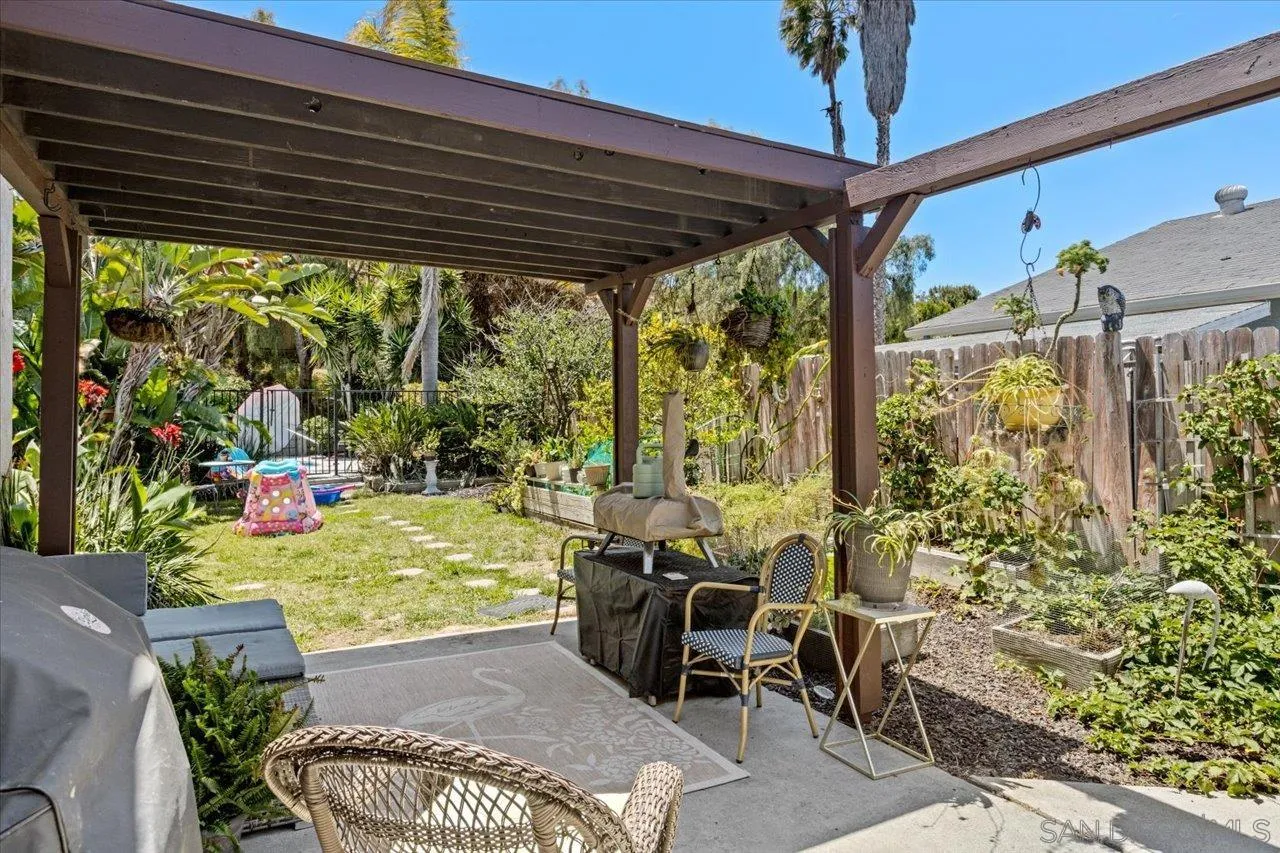 2337 Fallingleaf Road Oceanside, CA 92056 - Photo 23 of 34 a view of a patio with table and chairs and potted plants