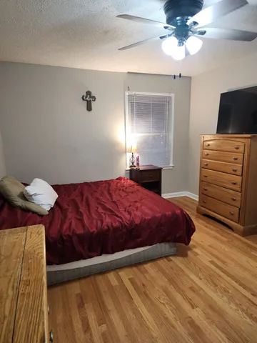 a bedroom with a bed and a chandelier