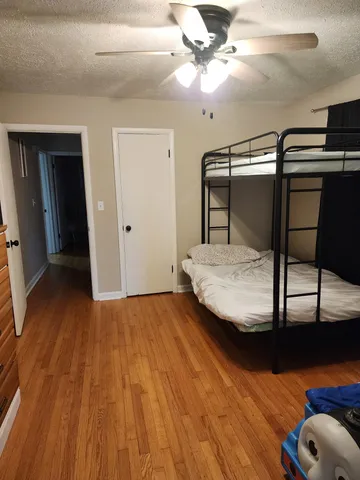 a bedroom with a bed and a chandelier