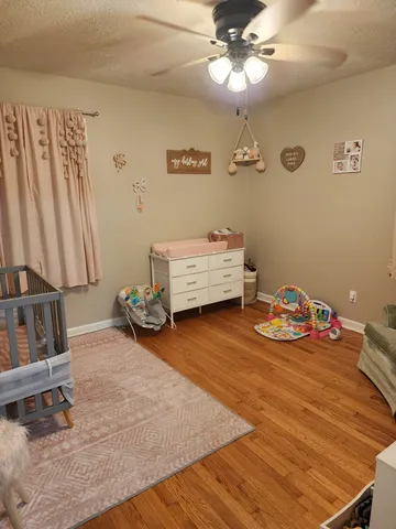 a bedroom with furniture and a chandelier
