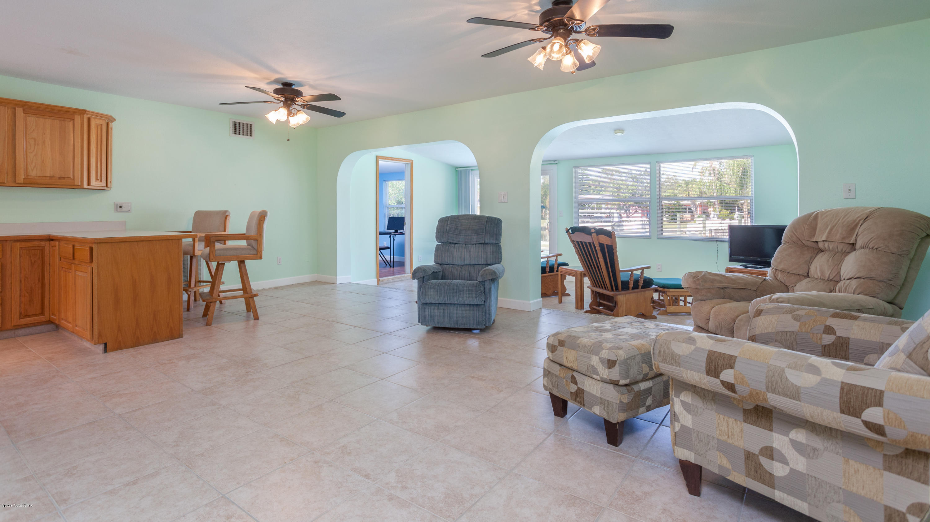 1035 Trinidad Road Cocoa Beach, FL 32931 - Photo 12 of 23 a living room with furniture and a chandelier