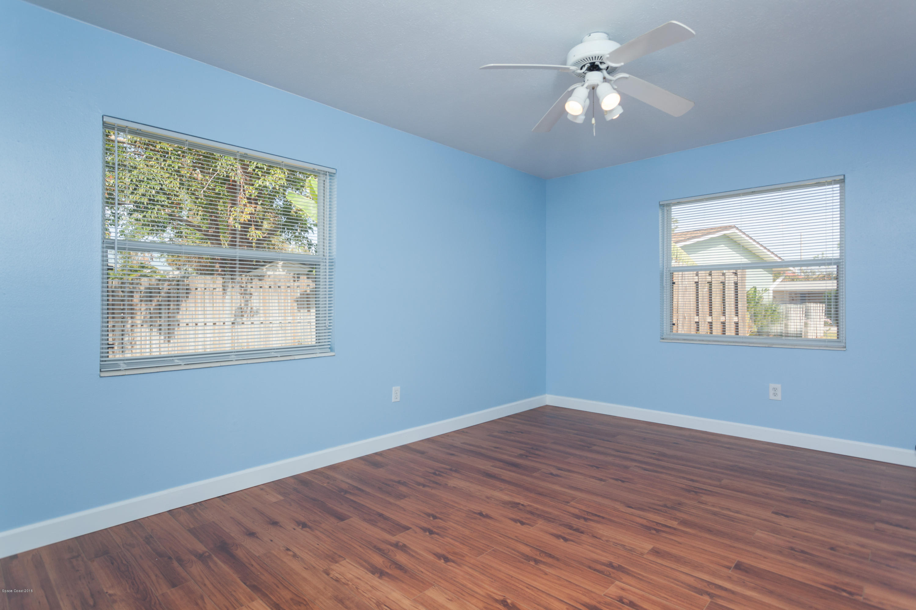 1035 Trinidad Road Cocoa Beach, FL 32931 - Photo 15 of 23 a view of empty room with wooden floor and fan