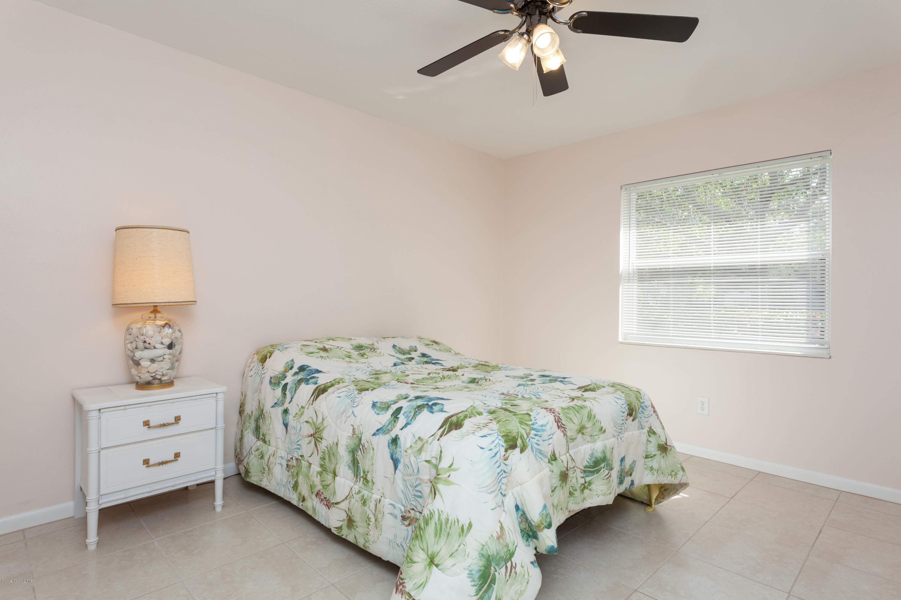 1035 Trinidad Road Cocoa Beach, FL 32931 - Photo 18 of 23 a bedroom with a bed and a window