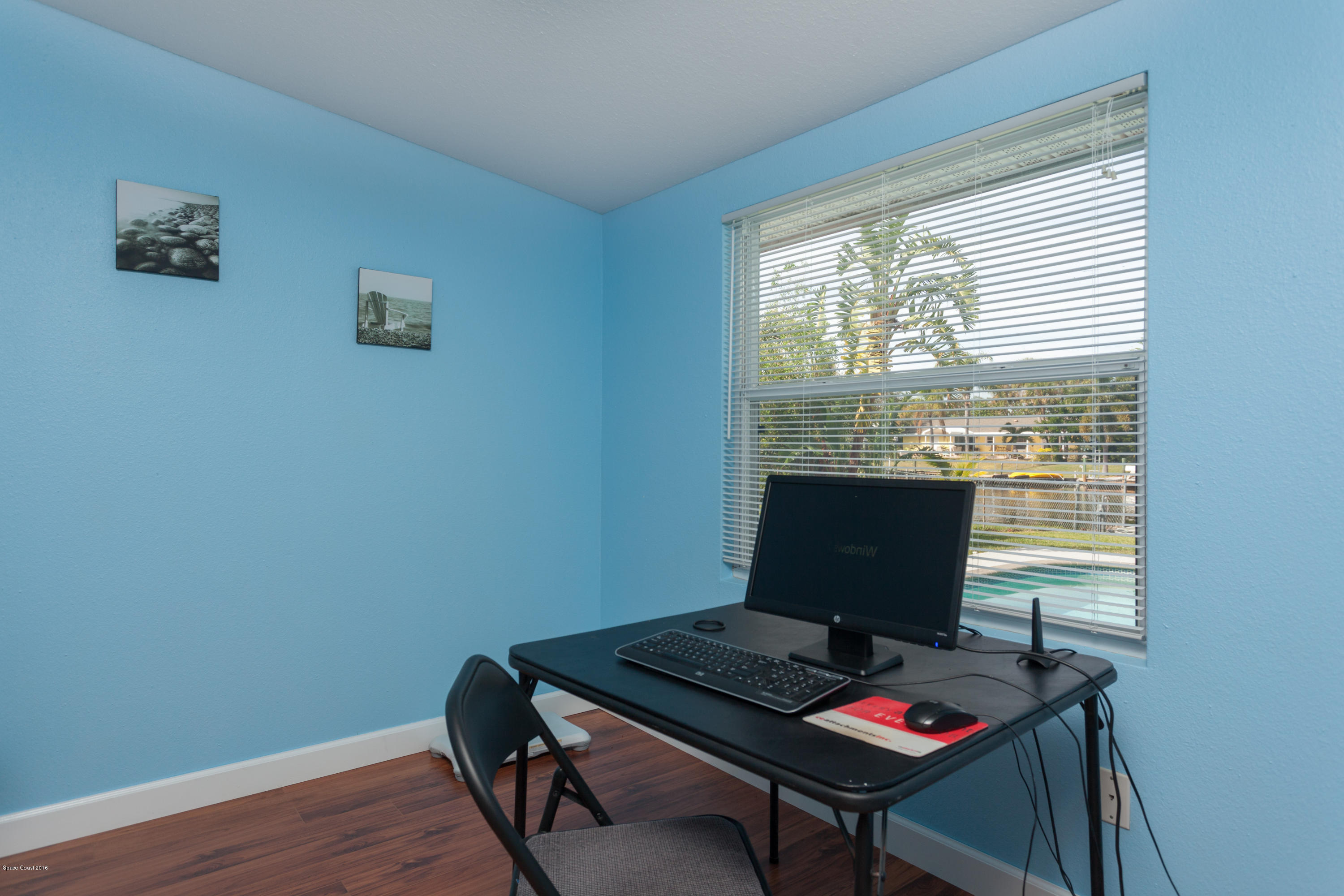 1035 Trinidad Road Cocoa Beach, FL 32931 - Photo 19 of 23 a view of a workspace with furniture and a window