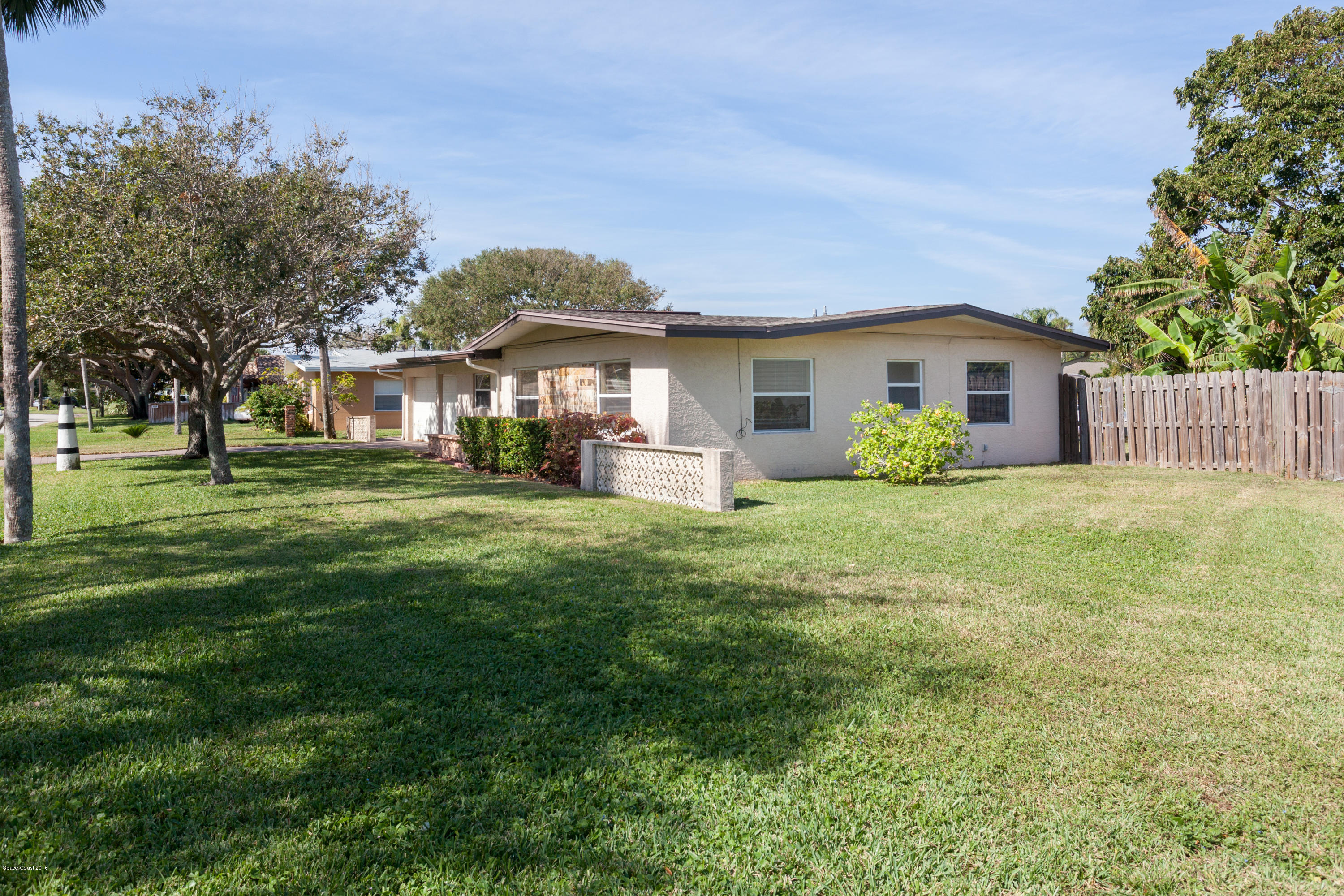 1035 Trinidad Road Cocoa Beach, FL 32931 - Photo 22 of 23 a front view of house with yard and green space