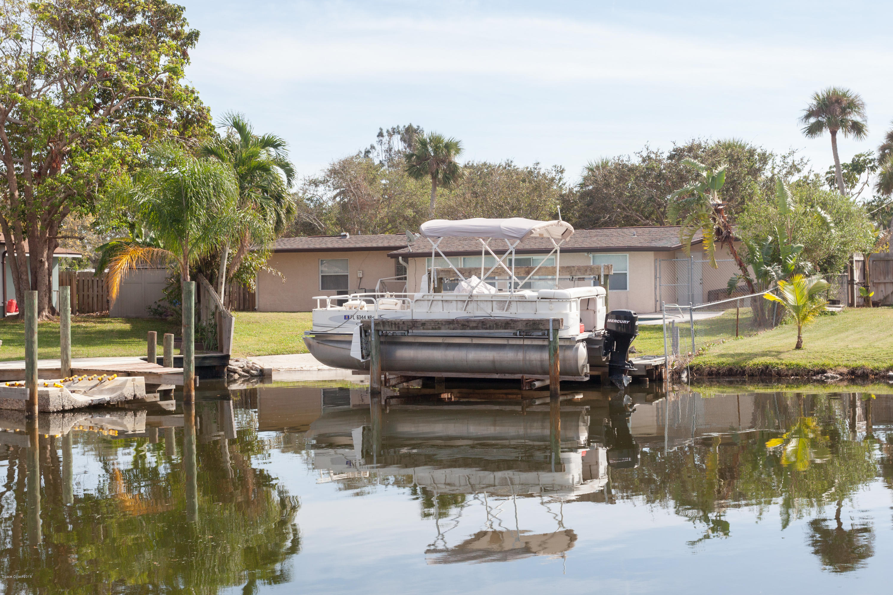 1035 Trinidad Road Cocoa Beach, FL 32931 - Photo 23 of 23 a view of a house with backyard water fountain and sitting area
