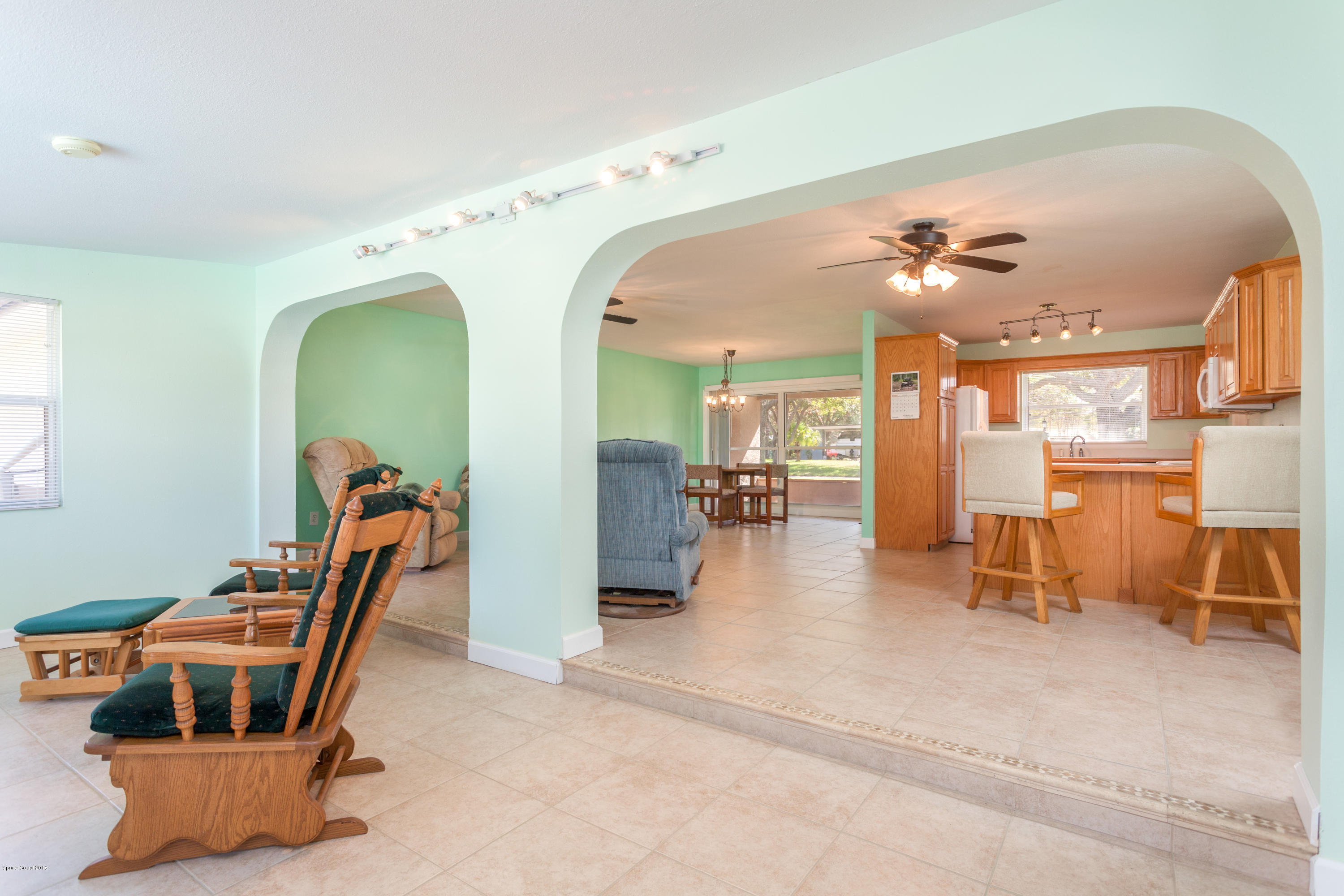 1035 Trinidad Road Cocoa Beach, FL 32931 - Photo 5 of 23 a dining room with furniture and a chandelier