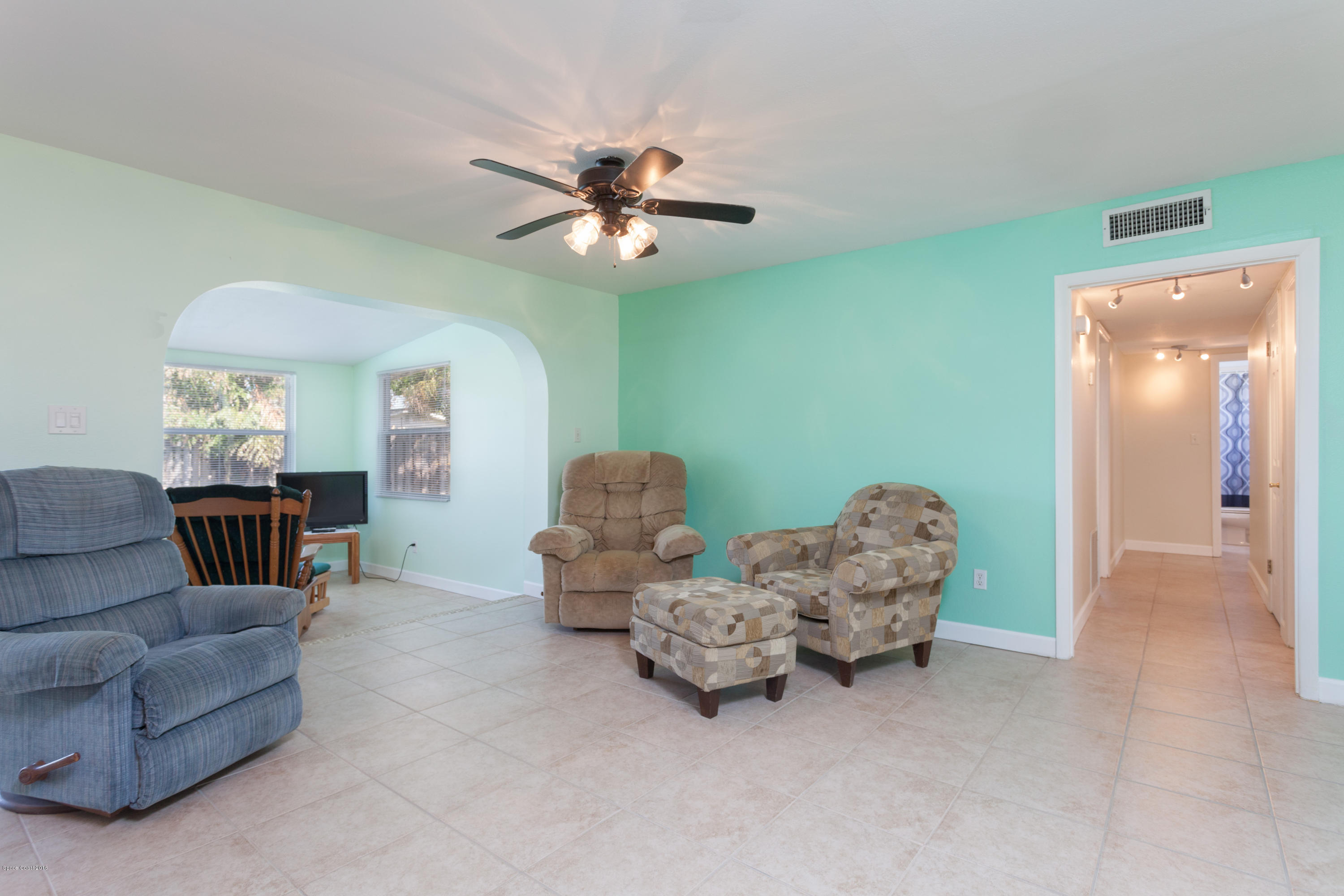 1035 Trinidad Road Cocoa Beach, FL 32931 - Photo 6 of 23 a living room with furniture and a chandelier
