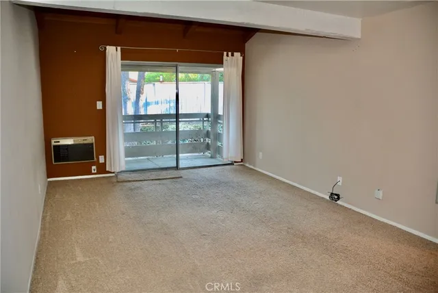 a view of an empty room with a sliding door