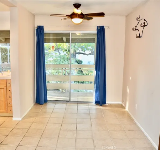 a view of an entryway with a floor to ceiling window and wooden floor