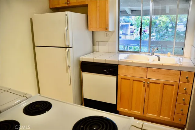 a kitchen with a refrigerator and a sink