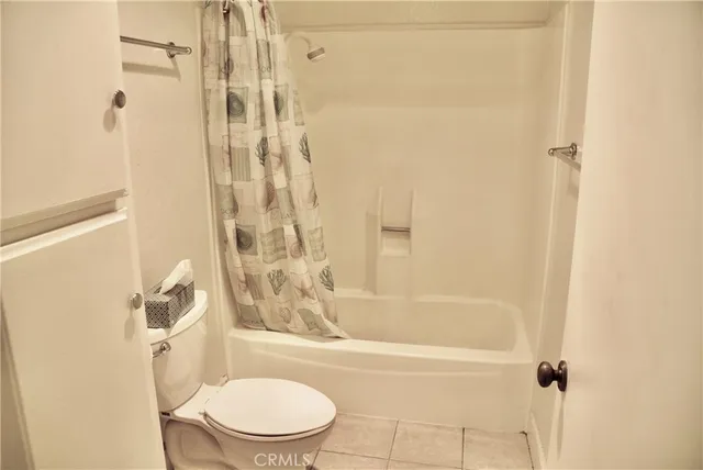 a bathroom with a toilet and shower