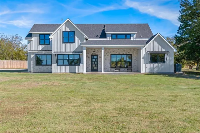 a front view of house with yard and glass windows