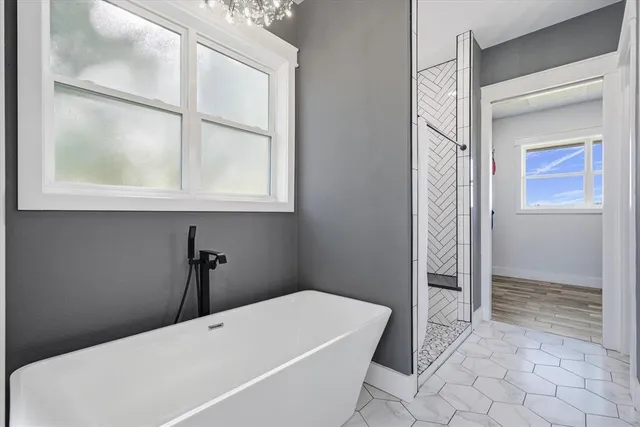 a bathroom with a tub and shower