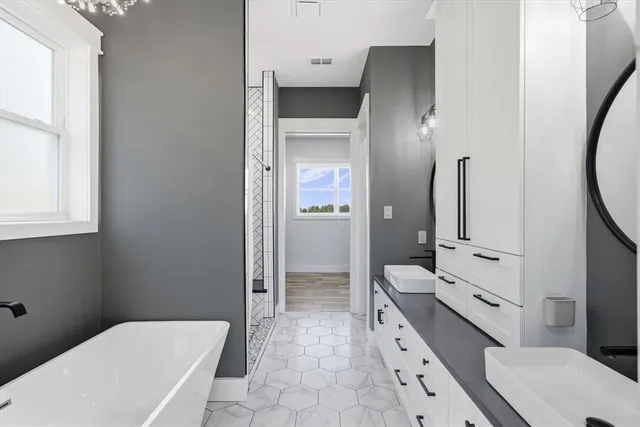 a bathroom with a double vanity sink toilet and shower