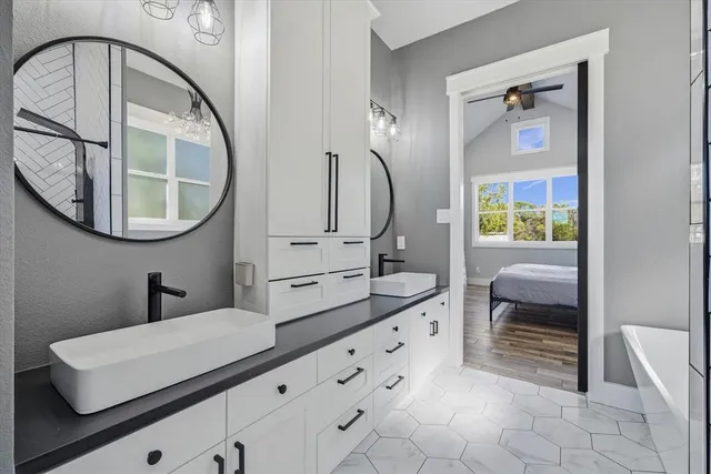 a en suite bathroom with a double vanity sink and a mirror