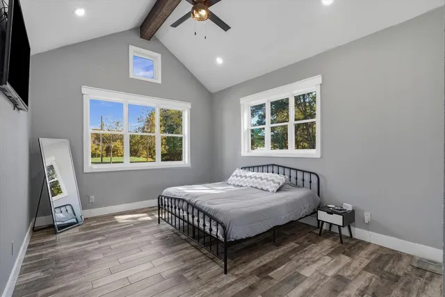 a bedroom with a bed and a window