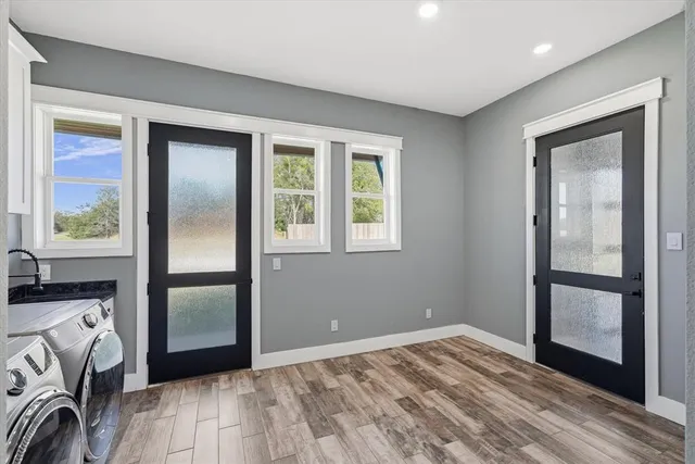 a view of a livingroom with wooden floor and a window