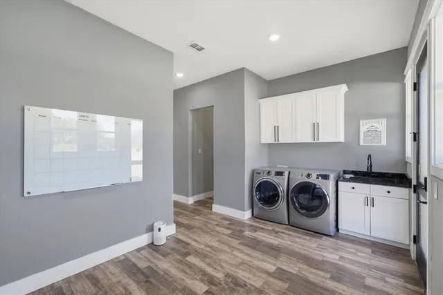 a utility room with sink dryer and washer