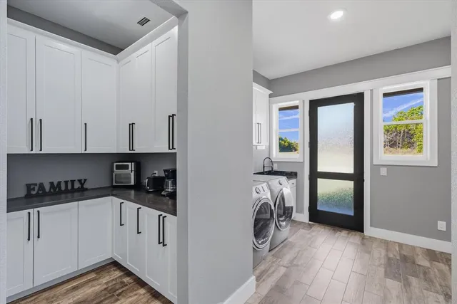 a kitchen with a refrigerator and a stove top oven