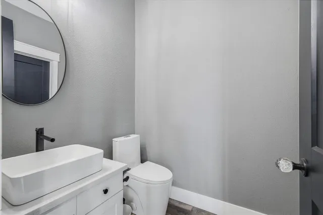 a bathroom with a toilet a sink and mirror