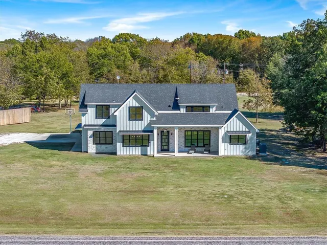 an aerial view of a house with a lake view