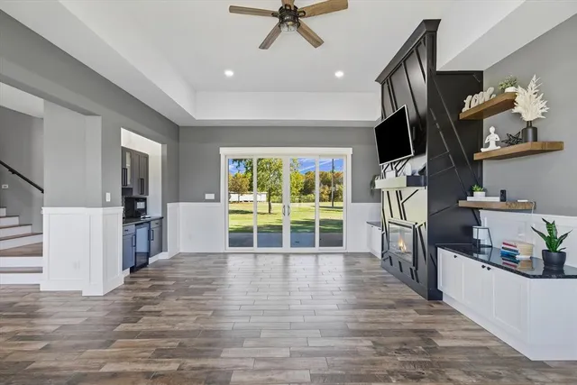 a view of a kitchen with wooden floor and a refrigerator