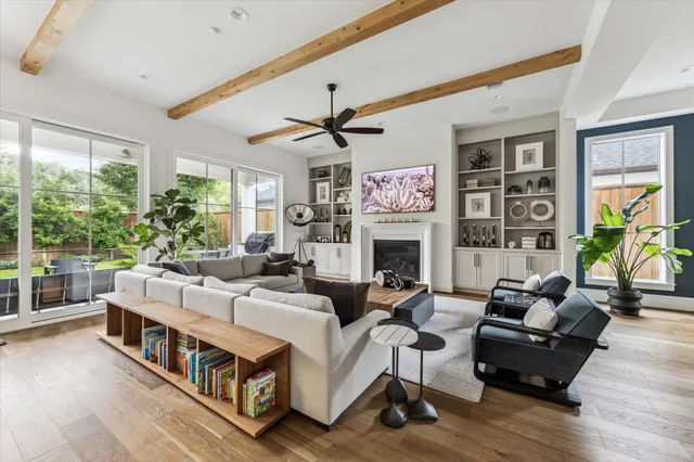a living room with fireplace furniture and a large window