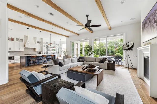 a living room with furniture a fireplace and a large window