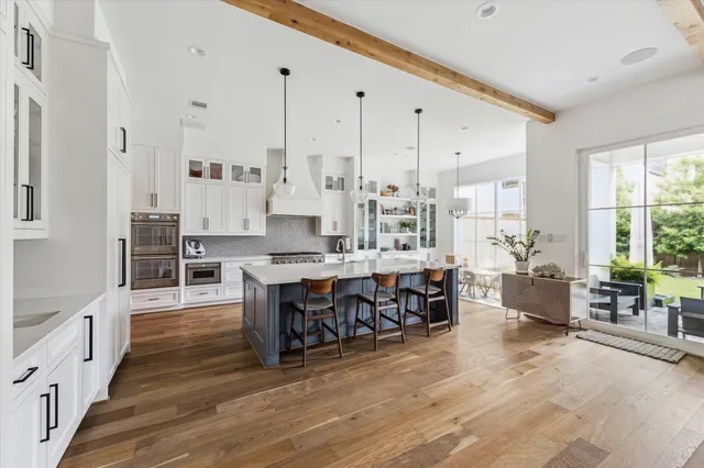 a large kitchen with lots of counter space and furniture