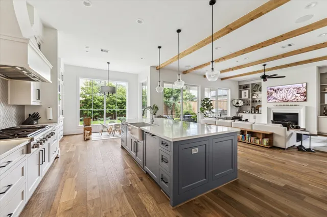a kitchen with stainless steel appliances granite countertop a stove and a wooden floors