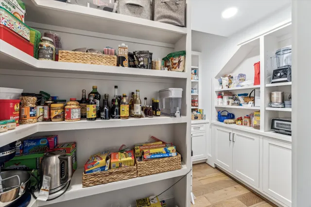 a cabinet with granite countertop lots of different kinds of books