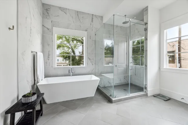 a spacious bathroom with a bathtub and a shower