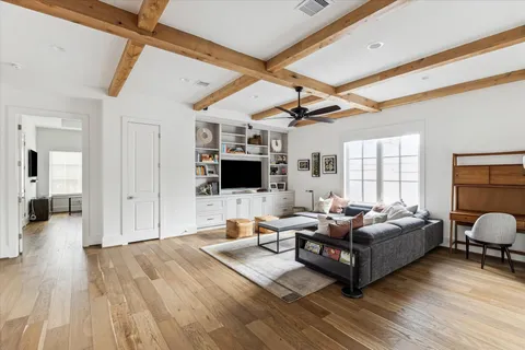 a living room with furniture flat screen tv and a fireplace