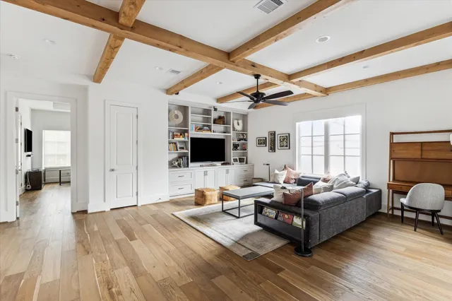 a living room with furniture flat screen tv and a fireplace