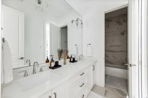 a bathroom with double sink and a mirror