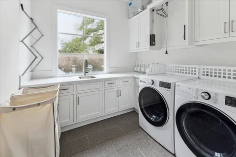 a utility room with sink dryer and washer