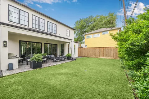 a view of house with backyard and garden