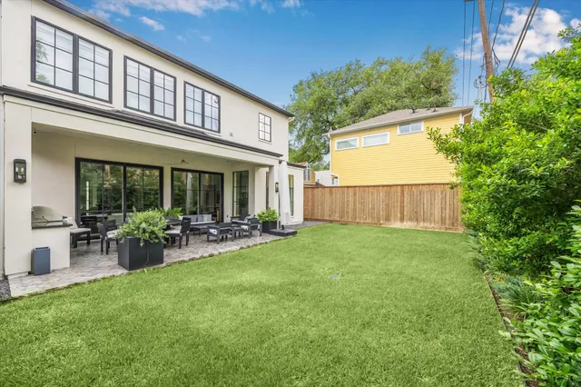 a view of house with backyard and garden