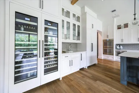 a kitchen with granite countertop a refrigerator and a stove